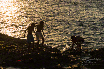 © 2014 Margo Taussig PiOfferings are thrown into the sea to nkerton.  All Rights Reserved.  From Barefoot Contessa Photo Adventures.  For usage and fees, please e-mail TBC (at) BCphotoadventures (dot) com or contact us at 310 Lafayette Drive, Hillsborough, NC  27278 or at 919-643-3036 before 9 p.m. Eastern Time, ET.